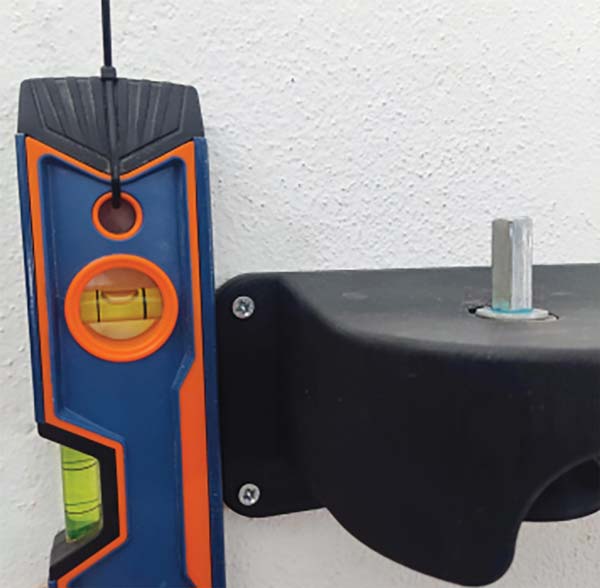 leveling the body of the can seamer while mounting on the wall
