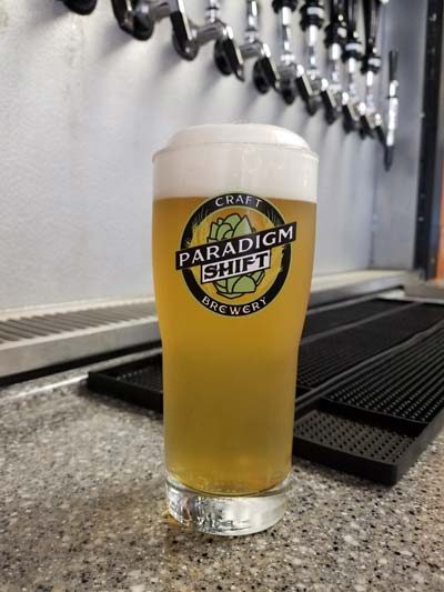 picture of neighbor girl tripel from paradigm shift craft brewery poured on tap